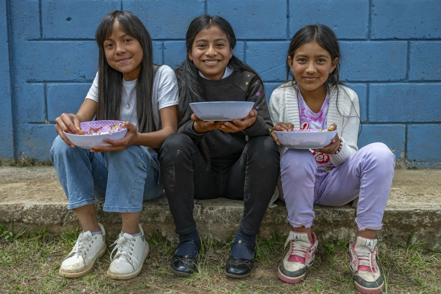 CRS_Action_ Recissions_2025 Catholic Relief Services Young Girls Eating from Bowls
