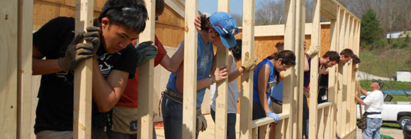 Featured Members Workers building a home raising a wall