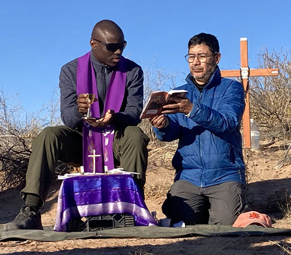 Two unidentified Jesuit priests concelebrate Mass in the Chihuahuan Desert in New Mexico Dec. 21, 2025, for a 20-year-old Guatemalan woman, whose remains were previously recovered in the area marked by the cross, and also for two women whose remains were found Dec 19. (OSV News photo/courtesy Collin Price)
